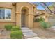 Inviting front entrance with a decorative door, stone steps, and low-maintenance desert landscaping at 12277 Bluebird Canyon Pl, Las Vegas, NV 89138