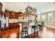 Gourmet kitchen with a granite island, stainless steel appliances, dark wood cabinets, and bar stool seating at 12277 Bluebird Canyon Pl, Las Vegas, NV 89138