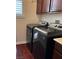 Convenient laundry room with modern washer and dryer, plus storage, adds functionality to the home at 12277 Bluebird Canyon Pl, Las Vegas, NV 89138