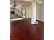 Bright living area with dark wooden floors, chandelier, and staircase with dark wood railing at 12277 Bluebird Canyon Pl, Las Vegas, NV 89138