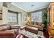Inviting living room with hardwood floors, comfortable seating, and natural light from shuttered windows at 12277 Bluebird Canyon Pl, Las Vegas, NV 89138