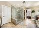 Bathroom featuring a stone shower, tile flooring, and a glimpse into the bedroom at 12277 Bluebird Canyon Pl, Las Vegas, NV 89138
