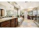 Large bathroom featuring double vanities, a soaking tub, and a walk-in shower at 12277 Bluebird Canyon Pl, Las Vegas, NV 89138
