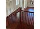 Elegant staircase with wooden railing, iron spindles, and hardwood steps, offering a view into the open living space at 12277 Bluebird Canyon Pl, Las Vegas, NV 89138
