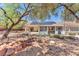 This backyard features desert landscaping, mature trees and a water feature at 1596 Fieldbrook St, Henderson, NV 89052