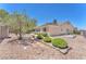 Well-maintained backyard with gravel landscaping and manicured bushes, providing a serene outdoor space at 1596 Fieldbrook St, Henderson, NV 89052