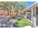 This backyard features mature trees, desert landscaping and a bridge at 1596 Fieldbrook St, Henderson, NV 89052