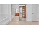 Bathroom featuring a soaking tub, a view into a walk in closet, and a glass shower at 1596 Fieldbrook St, Henderson, NV 89052