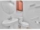 This bathroom features a pedestal sink, a toilet and grab bars at 1596 Fieldbrook St, Henderson, NV 89052