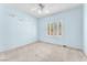This bedroom features light blue walls, white trim and a window with plantation shutters at 1596 Fieldbrook St, Henderson, NV 89052