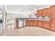 Well-lit kitchen with stainless steel appliances and beautiful hardwood cabinets at 1596 Fieldbrook St, Henderson, NV 89052