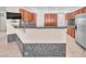 Well-appointed kitchen with bar seating, granite countertops, and stainless steel appliances at 1596 Fieldbrook St, Henderson, NV 89052