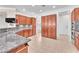 Well-lit kitchen featuring granite countertops, wood cabinetry, and stainless steel appliances at 1596 Fieldbrook St, Henderson, NV 89052