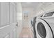 This laundry room features tile flooring and a window with plantation shutters at 1596 Fieldbrook St, Henderson, NV 89052
