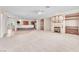 Open-concept living area with fireplace, built-in shelves, and breakfast bar at 1596 Fieldbrook St, Henderson, NV 89052