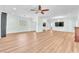 Expansive living room features wood floors, natural light, ceiling fan, and decorative chandelier at 1596 Fieldbrook St, Henderson, NV 89052