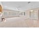 Bright living room with a fireplace, large windows, and plush carpeting at 1596 Fieldbrook St, Henderson, NV 89052