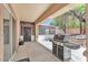This covered patio features a BBQ, exterior doors and access to the backyard at 1596 Fieldbrook St, Henderson, NV 89052