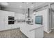 Bright, renovated kitchen featuring a large center island, white cabinetry, and stainless steel appliances at 1777 Indian Summer Dr, Las Vegas, NV 89123