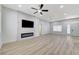 Bright living room with hardwood floors, fireplace, ceiling fan, and large windows at 1925 Hot Oak Ridge St, Las Vegas, NV 89134