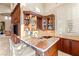 Stylish bar area with custom cabinetry, wine storage, a sink, a marble countertop, and seating at 23 Quiet Moon Ln, Las Vegas, NV 89135
