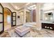 Well-lit bathroom with a soaking tub, dual vanities, and unique architectural details at 23 Quiet Moon Ln, Las Vegas, NV 89135