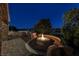 Picturesque backyard with a built in kitchen area, cozy fire pit, and spacious patio at 23 Quiet Moon Ln, Las Vegas, NV 89135