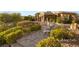 Serene front yard featuring a stone pathway, manicured bushes, and landscape lighting at 23 Quiet Moon Ln, Las Vegas, NV 89135
