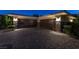 A spacious three-car garage featuring stone accents and a brick driveway at 23 Quiet Moon Ln, Las Vegas, NV 89135
