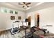 Well-lit home gym equipped with multiple machines and a view of the backyard at 23 Quiet Moon Ln, Las Vegas, NV 89135