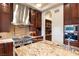 Gourmet kitchen with dual oven, high-end appliances, custom cabinets, coffee maker, and a tile backsplash at 23 Quiet Moon Ln, Las Vegas, NV 89135