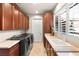 Convenient laundry room with modern appliances, custom cabinetry, and a sink at 23 Quiet Moon Ln, Las Vegas, NV 89135