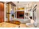 Spacious living room with a stone fireplace, custom built-ins, bar area, and sliding glass doors at 23 Quiet Moon Ln, Las Vegas, NV 89135