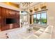 Beautiful living room showcasing automatic blinds, custom built-ins, sliding doors, and access to the outdoor pool at 23 Quiet Moon Ln, Las Vegas, NV 89135