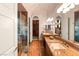 Opulent main bathroom with dual vanities, walk-in shower, and access to closet at 23 Quiet Moon Ln, Las Vegas, NV 89135