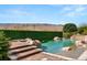 Backyard swimming pool features waterfalls, desert mountain views, and lush landscaping at 23 Quiet Moon Ln, Las Vegas, NV 89135