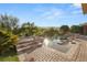 Spectacular backyard boasts a large pool, spa and meticulously hardscaped deck, ideal for outdoor entertaining at 23 Quiet Moon Ln, Las Vegas, NV 89135