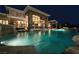 Tranquil backyard featuring a large pool with cascading waterfalls and a covered outdoor dining area at 23 Quiet Moon Ln, Las Vegas, NV 89135