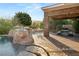 Outdoor patio features a large built in BBQ area, covered dining, and a relaxing poolside fire pit at 23 Quiet Moon Ln, Las Vegas, NV 89135