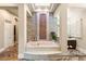 Relaxing soaking tub with a decorative water feature and tiled surround at 23 Quiet Moon Ln, Las Vegas, NV 89135
