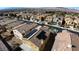 An aerial view showcasing a neighborhood featuring well-maintained homes with solar panels and a view of the Las Vegas valley at 257 Via Franciosa Dr, Henderson, NV 89011
