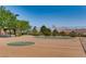 A basketball court surrounded by trees and green space at 257 Via Franciosa Dr, Henderson, NV 89011