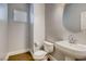 Powder room with tiled floor, pedestal sink, and window for natural light at 257 Via Franciosa Dr, Henderson, NV 89011