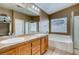 Well-lit bathroom featuring dual sinks, tub, and separate shower stall at 257 Via Franciosa Dr, Henderson, NV 89011