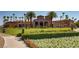 Community clubhouse with manicured landscaping, lawn, and palm trees at 257 Via Franciosa Dr, Henderson, NV 89011