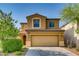 Charming two-story home featuring a tile roof, tan stucco exterior, and a two-car garage at 257 Via Franciosa Dr, Henderson, NV 89011