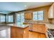 Open kitchen with granite countertops, stainless steel appliances, and sliding door to the backyard at 257 Via Franciosa Dr, Henderson, NV 89011