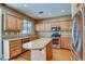 Modern kitchen with stainless steel appliances, island, and ample cabinet space for all your needs at 257 Via Franciosa Dr, Henderson, NV 89011