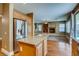 Spacious kitchen with granite countertops, stainless steel refrigerator, and a view of the living room at 257 Via Franciosa Dr, Henderson, NV 89011