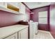 Well-lit laundry room with appliances, cabinets, and a window at 257 Via Franciosa Dr, Henderson, NV 89011